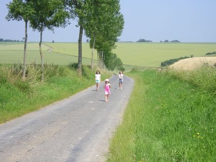 View from the position of Triangle Point facing north down Caterpillar Valley and the road to Bazentin Le Grand.  The children are 